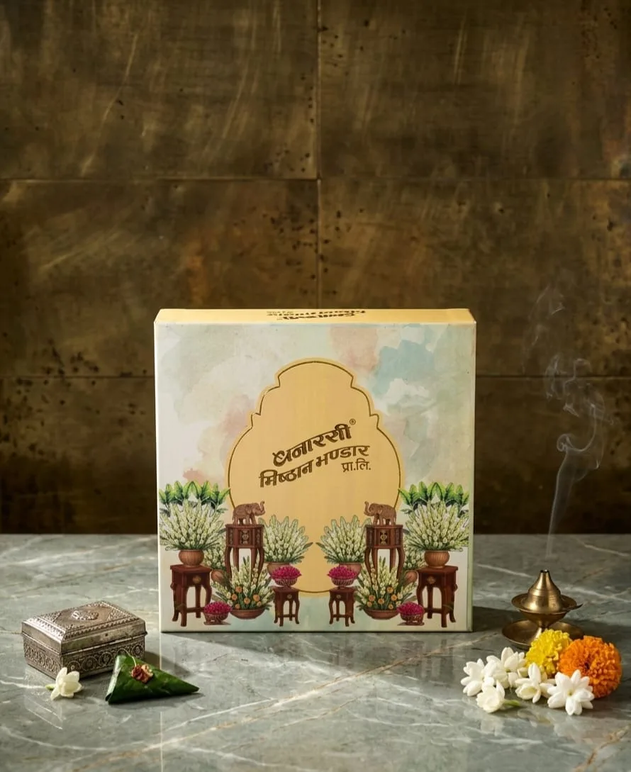 Open mithai box with gold foil trays and printed lid