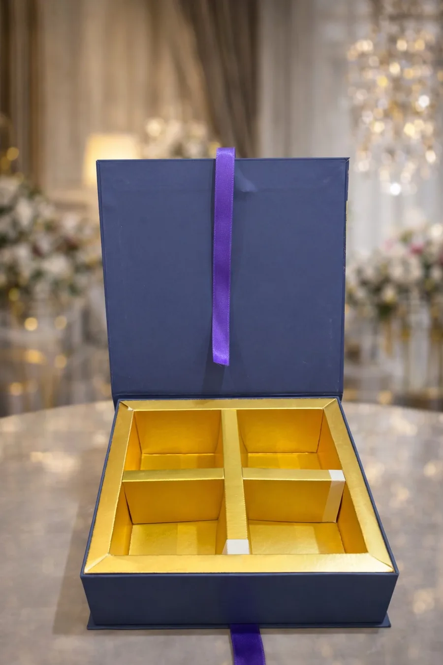 Navy rigid box open with gold compartments